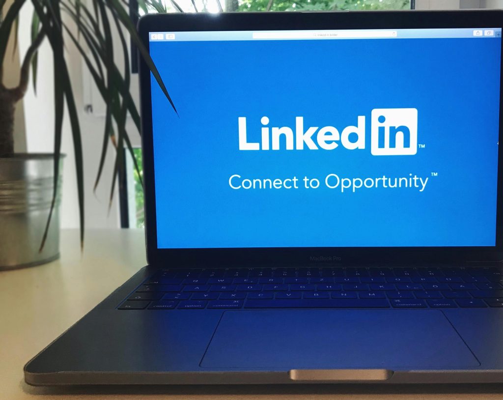 Social Media advertising A laptop screen displaying the LinkedIn logo with the text 'Connect to Opportunity'.